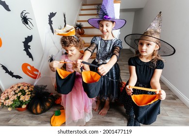 Girls Receiving Bunch Of Candies During Halloween Trick Or Treating