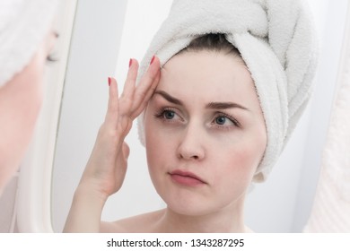 The girl's reflection in the mirror, discontent on the face of a young woman, close up - Shutterstock ID 1343287295