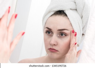 The girl's reflection in the mirror, sad on the face of a young woman, close up - Shutterstock ID 1345190726