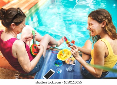 Girls relaxing by the swimming pool - Powered by Shutterstock