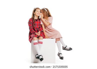 Girl's Secrets. Studio Shot Of Little Happy Girls In Retro Style Outfit, Fashion Of 70s, 80s Years Isolated On White Background. Concept Of Emotions, Facial Expression, Beauty. Copy Space For Ad