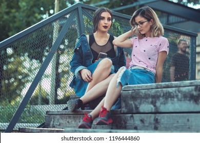 Girls Seriously Discussing About Their Studies On The First Day Of School. Standing Outside School In Trendy Outfit. Happiness Of Seeing Best Friend Is On Their Faces. Student Girls Back To School