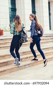 Girls Seriously Discussing About Their Studies On The First Day Of School. Standing Outside School In Trendy Outfit. Happiness Of Seeing Best Friend Is On Their Faces. Student Girls Back To School