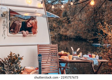 Girls Siblings Sisters Children Looking Out Of Window Of Cozy Kitchen In Trailer Mobile Home Or Recreational Vehicle During Autumn Family Local Travel Having Fun Together And Having Breakfast