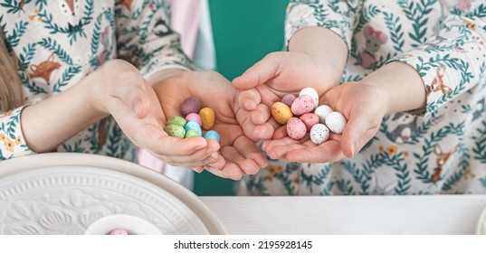 Girls, Sisters At Table With Easter Decoration. Celebration In Kitchen.Tablescape For Home Easter Holiday.Family Religious Traditional Festive Food, Meal. Colored Eggs,cake, Funny Bunny, Candy Sweet.