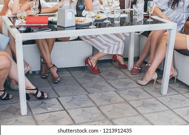 girls sit at the table, legs under the table