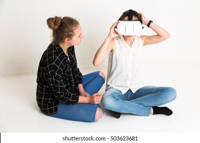 Girls Sitting On Floor Testing Head Mounted Display