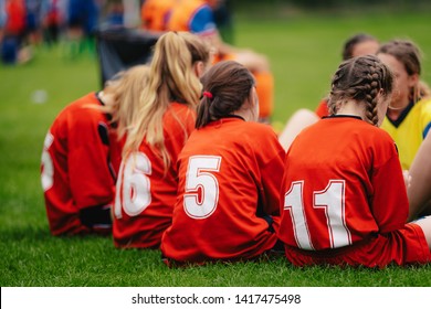 Girls in sports soccer team outdoors. Female physical education class on sports grass field. Young football players of female youth sports team