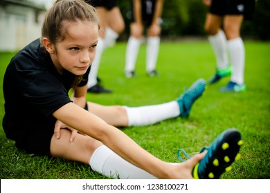 Girls stretching on the field
