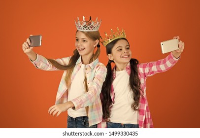 Girls Taking Selfie Photo Smartphone Camera. Spoiled Children Concept. Egocentric Princess. Kids Wear Golden Crowns Symbol Princess. Warning Signs Of Spoiled Child. Avoid Raising Spoiled Kids.