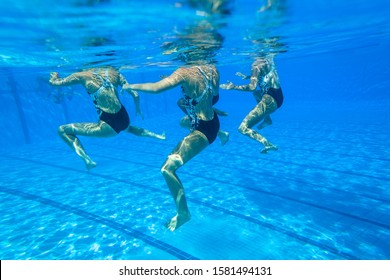 Girls Team Synchronized Dance Action Underwater Blue Water Outdoors Unrecognizable Swimming Pool.