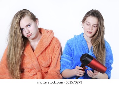 Girls Teens With Wet Hair. Upset With Broken Hairdryer In Her Hands. The Studio On White Background