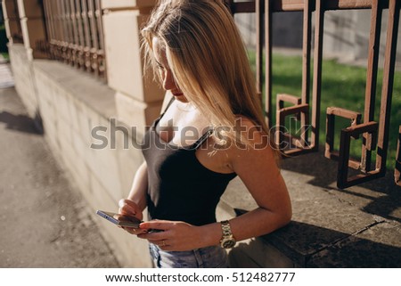 Woman with earphones listening music in smartphone