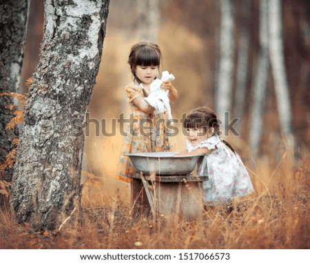 girls wash clothes in nature