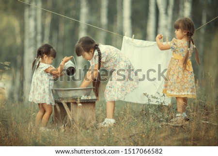 girls wash clothes in nature