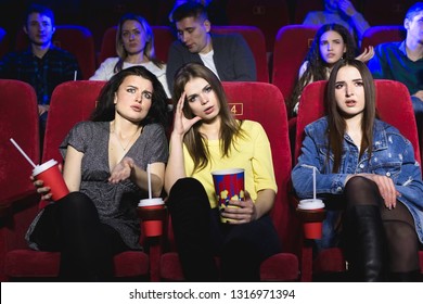 Girls Watching A Really Boring Movie At The Cinema Theater. Bad Film