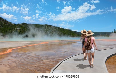 Girls Wearing Hats Hiking On Vacation. Beautiful Grand Prismatic Spring At Yellowstone National Park.