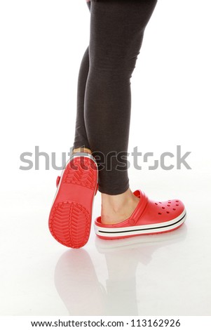 Girls wearing rubber shoes on white background