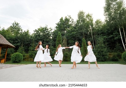 Girls In White Dresses Dance On The Square