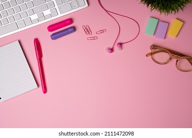 Girly Office Desk. Pink Stationery, Notebook, Pens, Eyeglasses, Markers, Sticky Notes And Paper Clips Of A Female Student