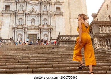 Girona medieval city, a young orange tourist on vacation at the Girona Cathedral, Catalonia's Costa Brava in the Mediterranean. Spain