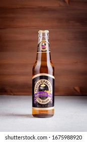 GIRONA, SPAIN - FEBRUARY 19, 2020: Flying Cauldron Butterscotch Beer, Famous Drink From Harry Potter World On Wooden Background, Studio Shot Still Life