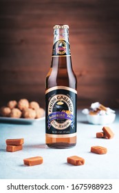 GIRONA, SPAIN - FEBRUARY 19, 2020: Flying Cauldron Butterscotch Beer, famous drink from Harry Potter world on wooden background, studio shot still life