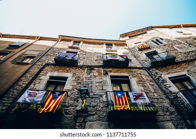 Girona, Spain - July 10, 2018: Catalonia Independence Flags On Balconies. The Catalan Independence Movement Is A Political Movement Historically Derived From Catalan Nationalism