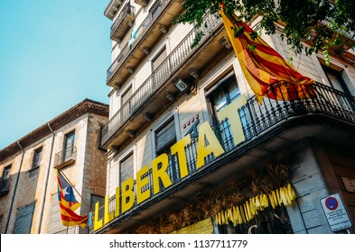 Girona, Spain - July 10, 2018: Catalonia Independence Flags On Balconies. The Catalan Independence Movement Is A Political Movement Historically Derived From Catalan Nationalism