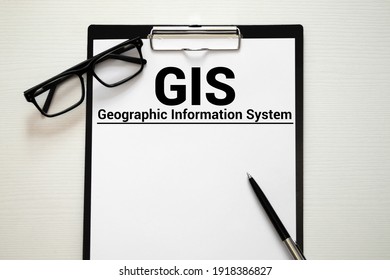 GIS - Geographic Information System Write On A Book Isolated On Wooden Table