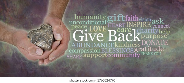  Give Back from the Heart Word Cloud - male hands gently cupped around a wooden heart beside a  GIVE BACK word tag cloud against a wide rustic dark multicoloured grunge background
                     - Shutterstock ID 1768824770