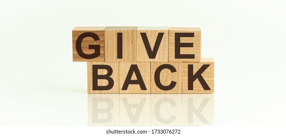 Give Back Word Written On Wood Block. Give Back Text On On The White Background.