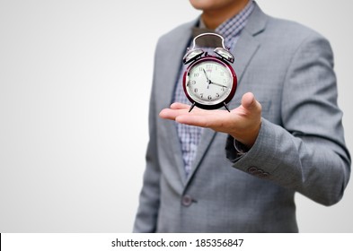 Give More Time Concept, Alarm Clock In Businessman Hand