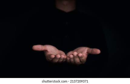 Give two hands with nothing on both on dark background with copy space. Close-up receiving gesture of outstretched cupped empty open hands. Concept of giving, donation, receiving, asking, and bribery. - Shutterstock ID 2137209371
