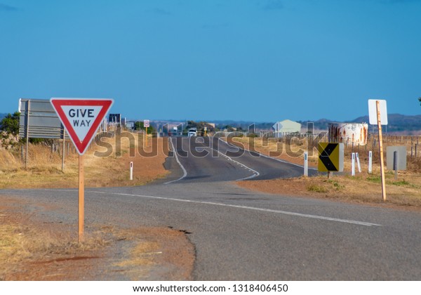 Give Way street sign at on of Australia\'s endless\
Outback roads