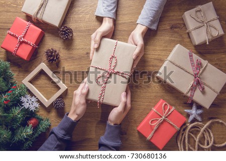 Gives a gift Christmas presents laid on a wooden table decoration background. Xmas concept.