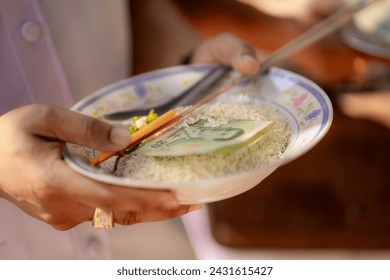 Giving alms to monks and making merit Buddhist dry food - Powered by Shutterstock