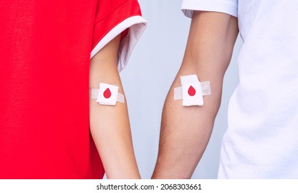 Giving Blood Saves Lives. Blood Donation. Man And Woman Blood Donors With Bandage