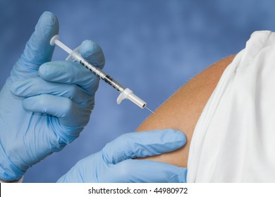 Giving a flu shot from a needle.