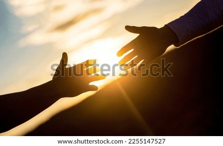 Giving a helping hand. Rescue, helping gesture or hands. Friendly handshake, friends greeting, teamwork, friendship. The outstretched hands, salvation, help silhouette, concept of help.
