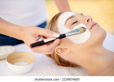 Giving Her Skin The Special Treatment. Shot Of A Young Woman Getting A Facial At A Spa.