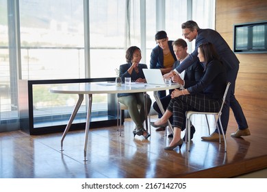 Giving his input. Shot of a group of corporate businesspeople working in the boardroom.