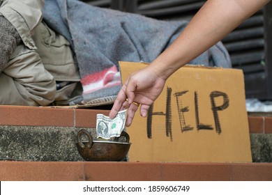 Giving money to homeless men on the side of the road.