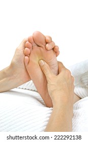 Giving Reflexology Treatment - Reflexologist Holding Patient's Foot Applying Pressure To The Solar Plexus Region