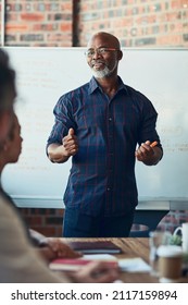 Giving Them An In-depth Explanation. Cropped Shot Of A Mature Businessman Giving A Presentation In The Boardroom.