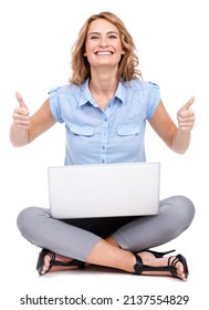 Giving you the thumbsup. Full length portrait of an attractive young woman giving two thumbs up while using her laptop.