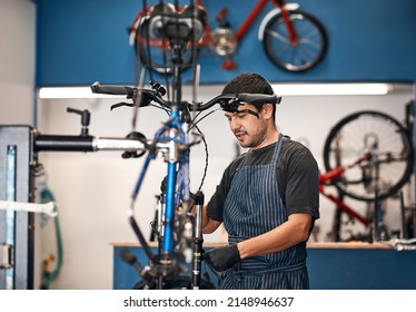 Giving your bike the attention it deserves. Shot of a man working in a bicycle repair shop. - Powered by Shutterstock