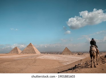 Giza, Cairo  Egypt -  January 25, 2020 : The view of the pyramids and camel riders from the panorama during the day