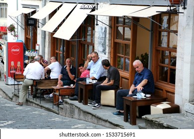 Gjirokastra, Albania - July 20 2018: Albanian People Sitting At The Cafe.