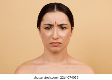 Glabellar Lines. Portrait Of Unhappy Young Indian Woman Frowning While Looking At Camera, Beautiful Hindu Female With Brow Furrow Standing Isolated Over Beige Studio Background, Copy Space - Shutterstock ID 2264074055